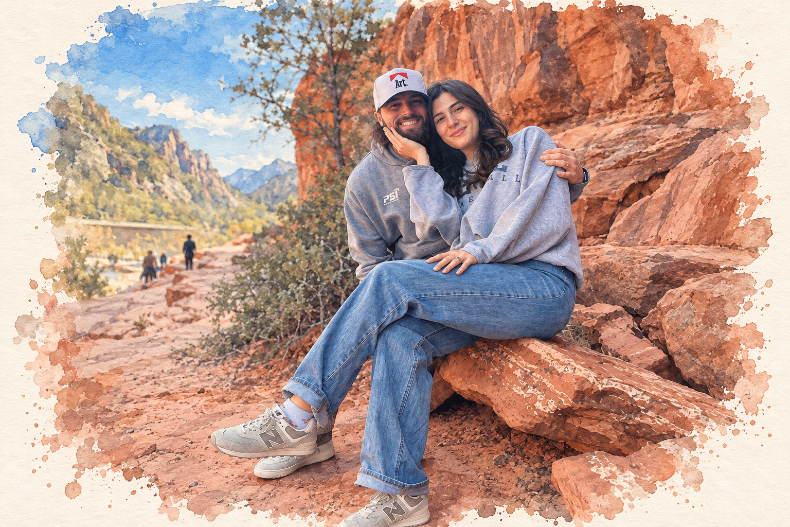 Nick and Mariella sitting together on red sandstone rocks along a desert canyon trail